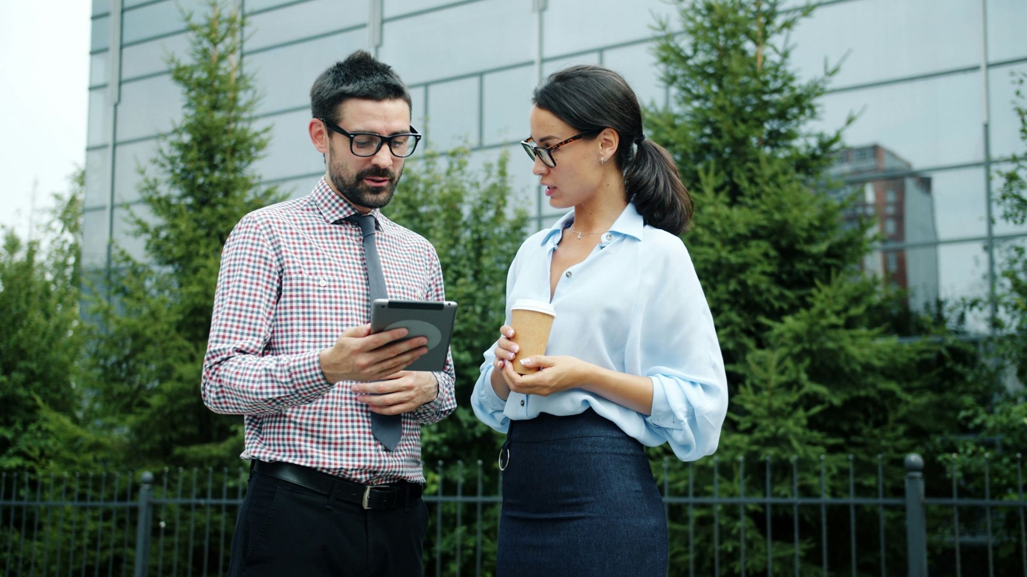Colleagues sharing a tablet outdoors